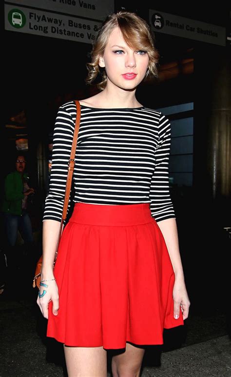 Taylor Swift left her apartment in New York City a couple of days ago wearing a Steve Alan Crossover Shirt ($178.00), a pair of Joe’s Jeans Slim Fit Pants ($148.00) in Red Berry, a pair of Prada Leather Round Toe Pumps (sold out), her new favourite Ray-Ban Wayfarer Lightforce Sunglasses ($185.00) and a Tod’s …